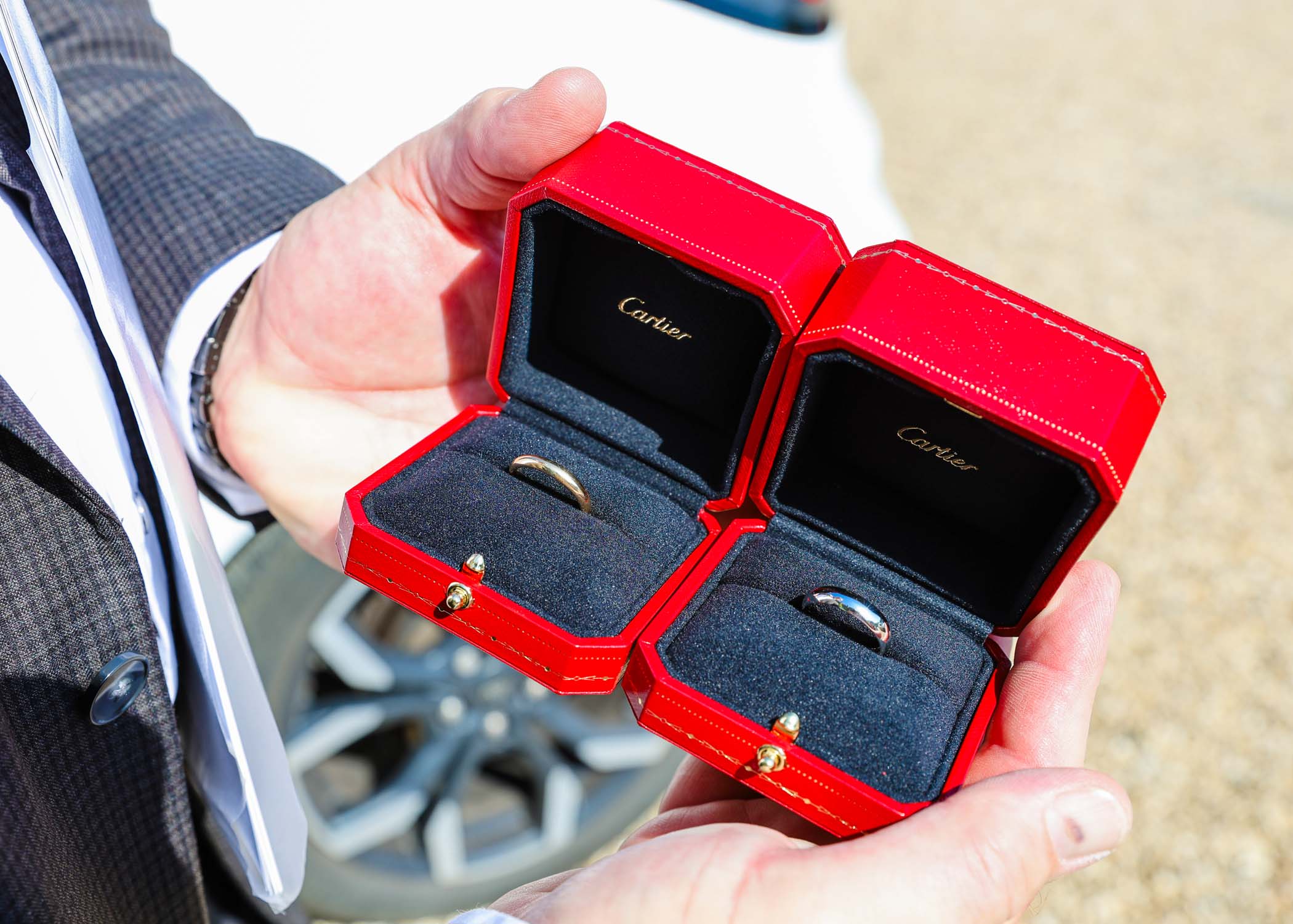 Wedding rings in bright red cartier wedding ring boxes on a wedding day in Woodbridge captured by Suffolk Wedding Photographer Hayley Denston Photography
